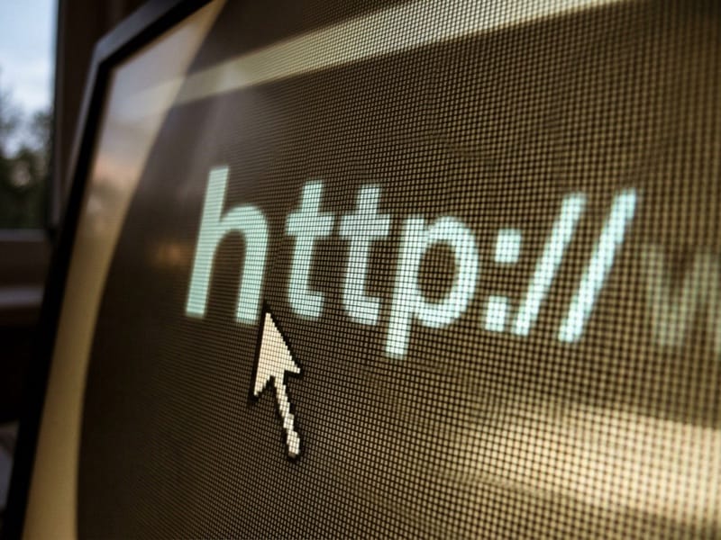 Computer screen close-up showing a cursor beside http in a browser address bar