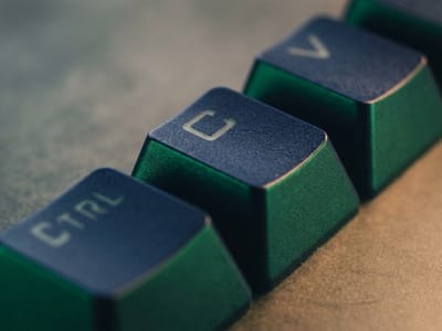 Close-up of dark green Ctrl, C and V keys from a computer keyboard
